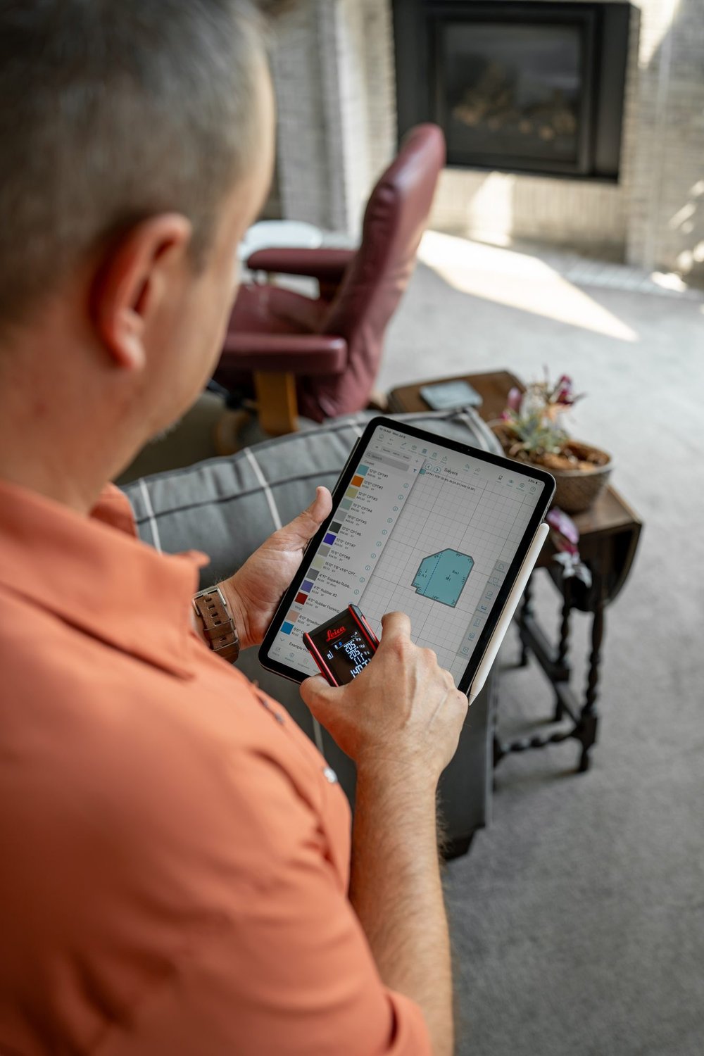Laser measuring a room on a tablet for a carpet installation estimate in Boise, Idaho