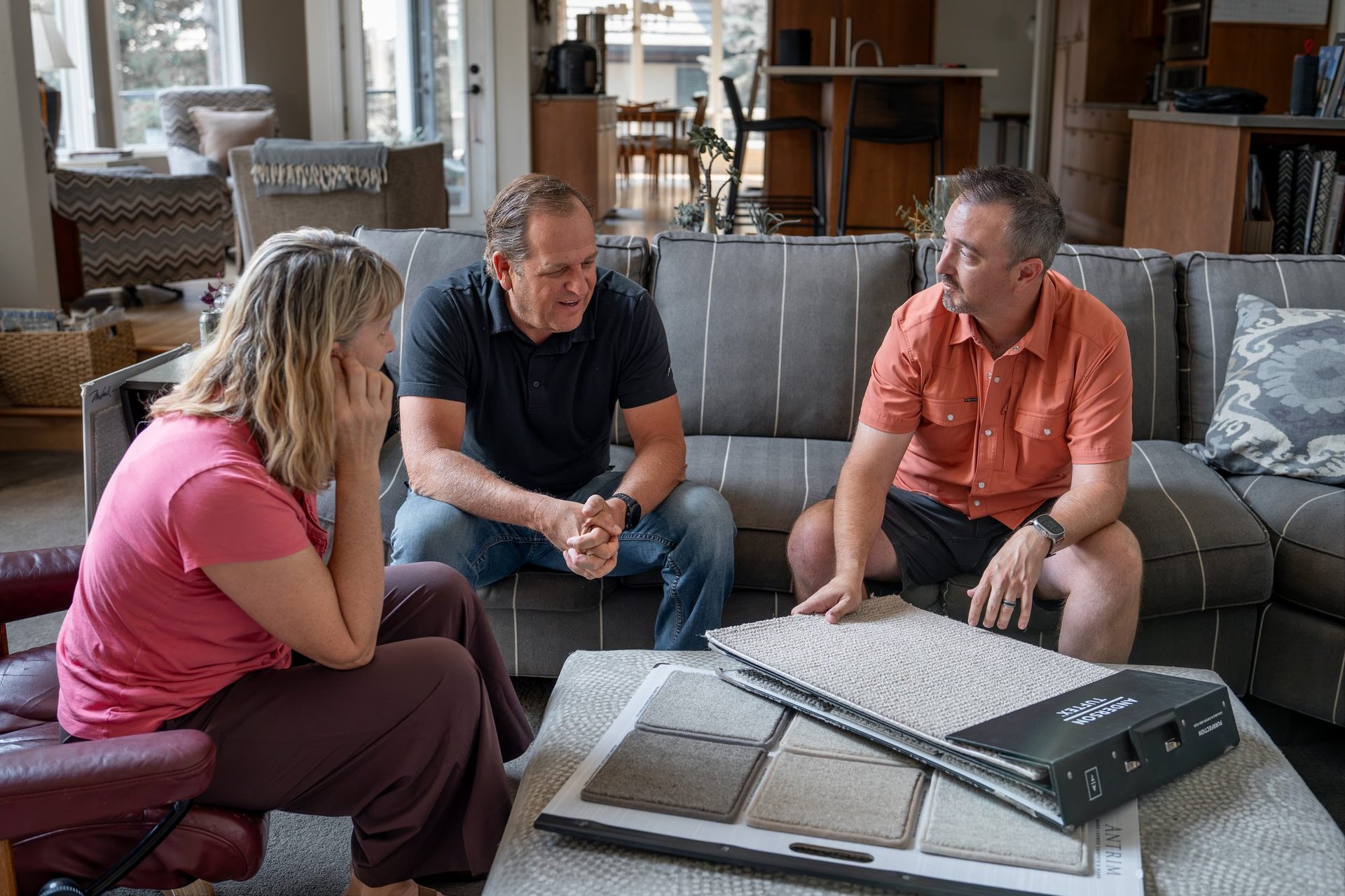 Erik Burns walking homeowners through carpet fiber and texture options in Boise, Idaho